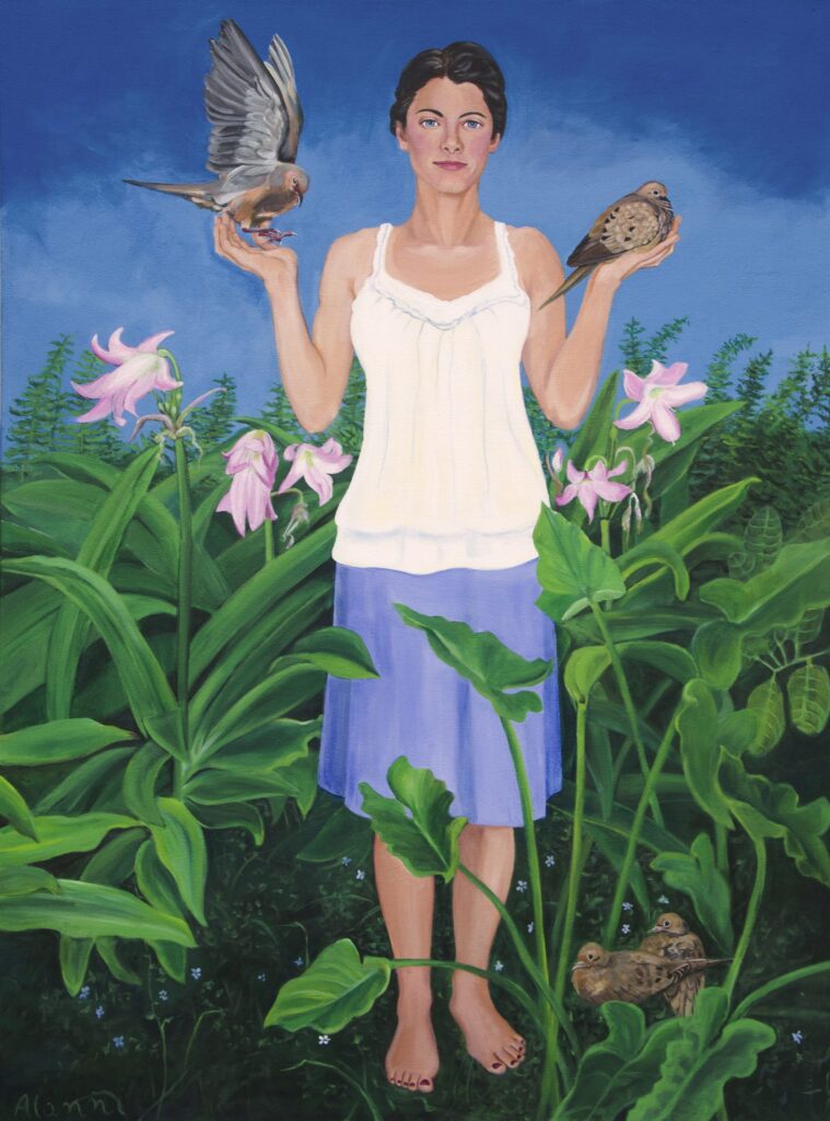 A woman in her garden holding doves in her hands